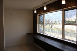 造作のカウンターを設けて、家事の時のアイロンがけや本を読んだり等色々な用途として使え、また座った時には外の気配を感じとれるような窓高さとした